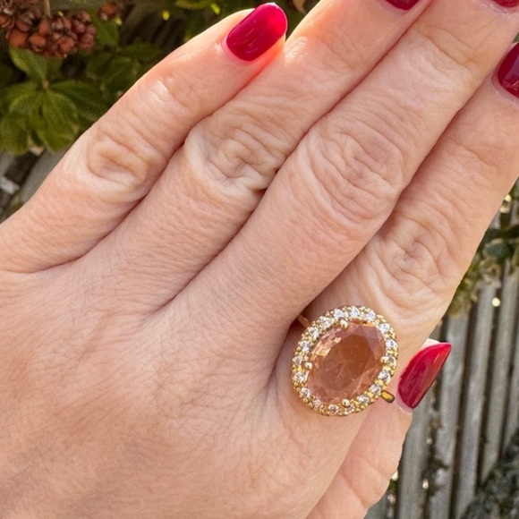 Elegant Gold Oval Halo Ring with Central Peach Gemstone - Picture 1 of 3